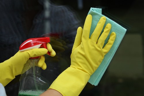 Carpet cleaning technician using safe practices in Bromley home
